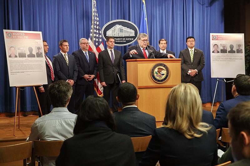 From left, Principal Associate Deputy Attorney General Seth Ducharm, Chris Hacker, Special Agent in Charge of FBI Atlanta, Assistant Attorney General Brian Benczkowski, Attorney General William Barr, Assistant Attorney General John Demers, and U.S. Attorney for the Northern District of Georgia Byung "BJay" Pak, attend a news conference, Monday, Feb. 10, 2020, at the Justice Department in Washington. Four members of the Chinese military have been charged with breaking into the networks of the Equifax credit reporting agency and stealing the personal information of tens of millions of Americans, the Justice Department said Monday, blaming Beijing for one of the largest hacks in history. (AP Photo/Jacquelyn Martin)