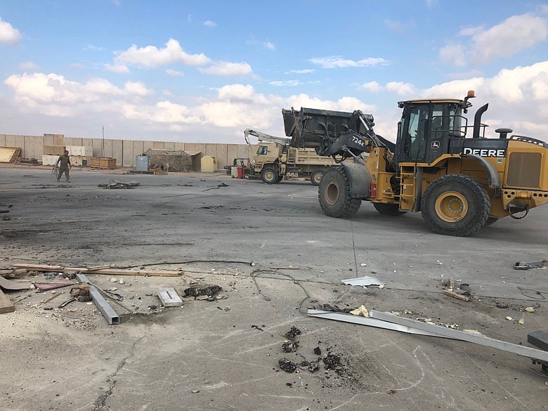 A bulldozer clears rubble and debris at Ain al-Asad air base in Anbar, Iraq, Monday, Jan. 13, 2020. Ain al-Asad air base was struck by a barrage of Iranian missiles in retaliation for the U.S. drone strike that killed atop Iranian commander, Gen. Qassem Soleimani, whose killing raised fears of a wider war in the Middle East. (AP Photo/Qassim Abdul-Zahra)