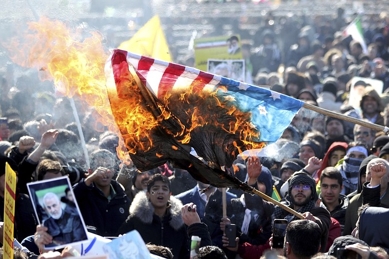 Iranian demonstrators burn a U.S. flag during a rally at Azadi (Freedom) Square celebrating the 41st anniversary of the Islamic Revolution, in Tehran, Iran, Tuesday, Feb. 11, 2020.Hundreds of thousands across Iran mark the anniversary of the 1979 Islamic Revolution amid some of the highest tensions with Washington in decades while Iran's president denounces America and urges the crowds to vote in parliamentary elections this month. (AP Photo/Ebrahim Noroozi)