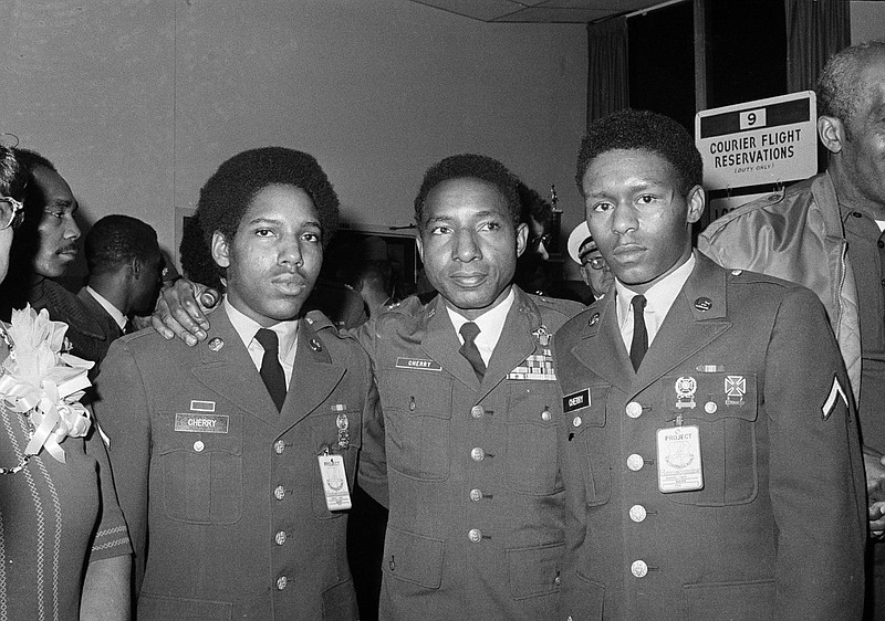 Former POW, Air Force Col. Fred Cherry, center, of Suffolk, Va., poses with his two sons, Don, 19, right, and Fred, 17, both PFCs in the Army, after returning to Andrews Air Force base near Washington, D.C., Feb. 16, 1973. Cherry was one of seven POWs who were flown to Washington. (AP Photo/Bob Daugherty)