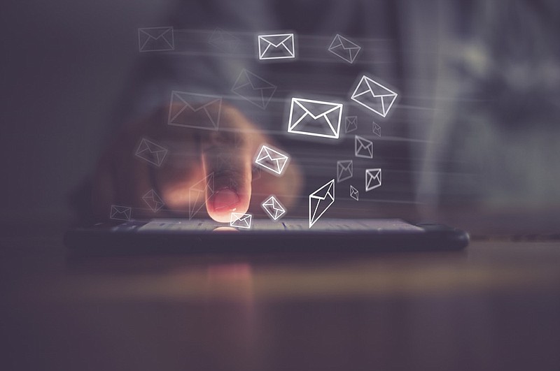 Man hand using phone with email icon, Email concept email tile emails tile / Getty Images