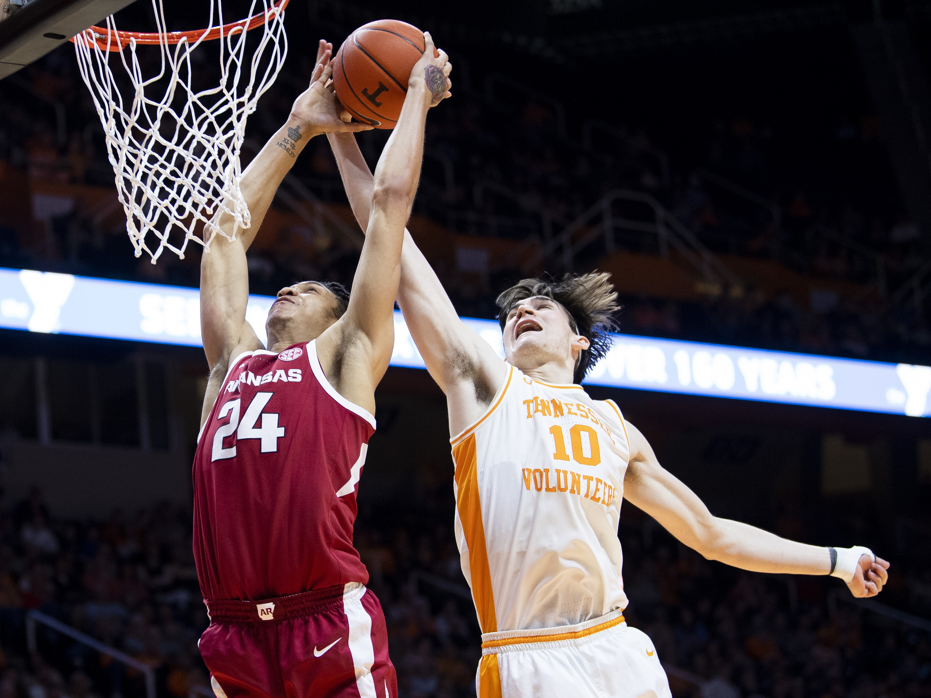 Tennessee forward John Fulkerson (10) blocks a shot by Arkansas forward Ethan Henderson (24) during an NCAA college basketball game, Tuesday, Feb. 11, 2020 in Knoxville, Tenn. (Brianna Paciorka/Knoxville News Sentinel via AP)