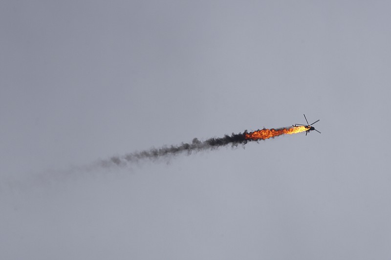 Syrian government helicopter is shot by a missile in Idlib province, Syria, Tuesday, Feb. 11, 2020. Syrian rebels shot down a government helicopter Tuesday in the country's northwest where Syrian troops are on the offensive in the last rebel stronghold. (AP Photo/Ghaith Alsayed)