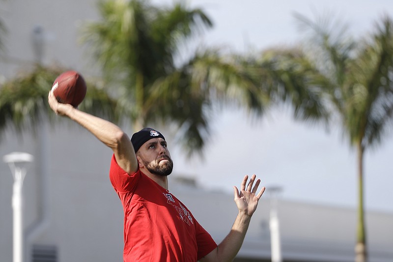 Boston Red Sox relief pitcher Matt Barnes (32) throws a football after reporting for spring training baseball Tuesday, Feb. 11, 2020, in Fort Myers, Fla. (AP Photo/John Bazemore)