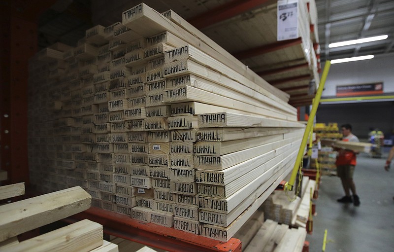 FILE - In this July 11, 2019, file photo lumber is stacked at the Home Depot store in Londonderry, N.H. Don't let your desire to upgrade your home downgrade your home's market value. Before you make a renovation fantasy a reality, consider whether the project will pay off when you're ready to sell. (AP Photo/Charles Krupa, File)