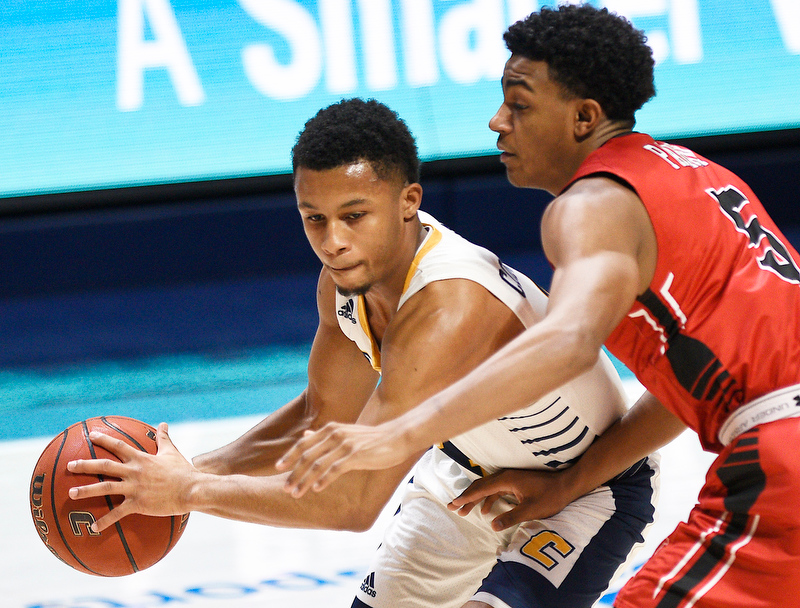 Staff Photo by Robin Rudd / UTC's Maurice Commander (4) looks to pass around VMI's Greg Parham (5). The University of Tennessee at Chattanooga Mocs hosted the Virginia Military Institute Keydets in Southern Conference basketball at McKenzie Area in Chattanooga, Tenn. on February 12, 2020.