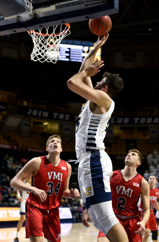 Staff Photo by Robin Rudd / UTC's Ramon Vila scores in front of VMI's Jake Stephens (34) and Garrett Gilkeson (2) in the Mocs' 86-67 Southern Conference win Wednesday night at McKenzie Arena. Vila totaled 23 points.