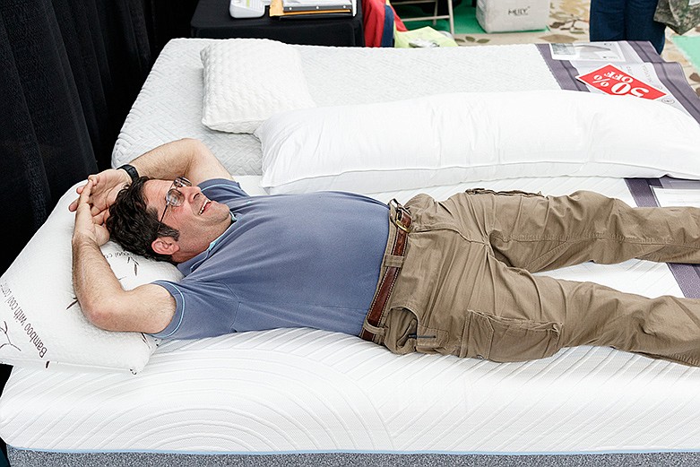 Jake, who declined to give his last name, tests out a mattress at the 52nd Tri-State Home Show at the Chattanooga Convention Center on Saturday, March 3, 2018, in Chattanooga, Tenn. / Staff file photo