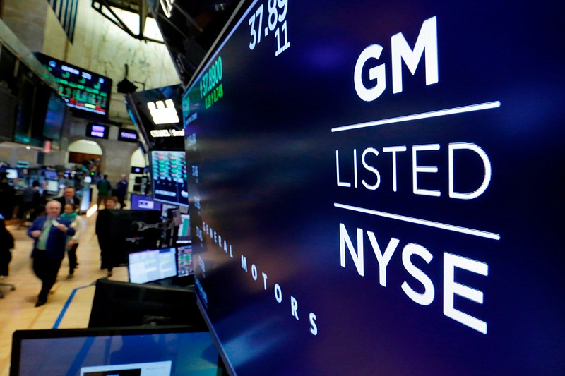 FILE - In this April 23, 2018, file photo, the logo for General Motors appears above a trading post on the floor of the New York Stock Exchange. Despite a 40-day strike by factory workers and slumping sales in the U.S. and China, General Motors still made money in 2019. The company posted a $6.58 billion profit for the year, but that was down almost 17% from 2018. (AP Photo/Richard Drew, File)