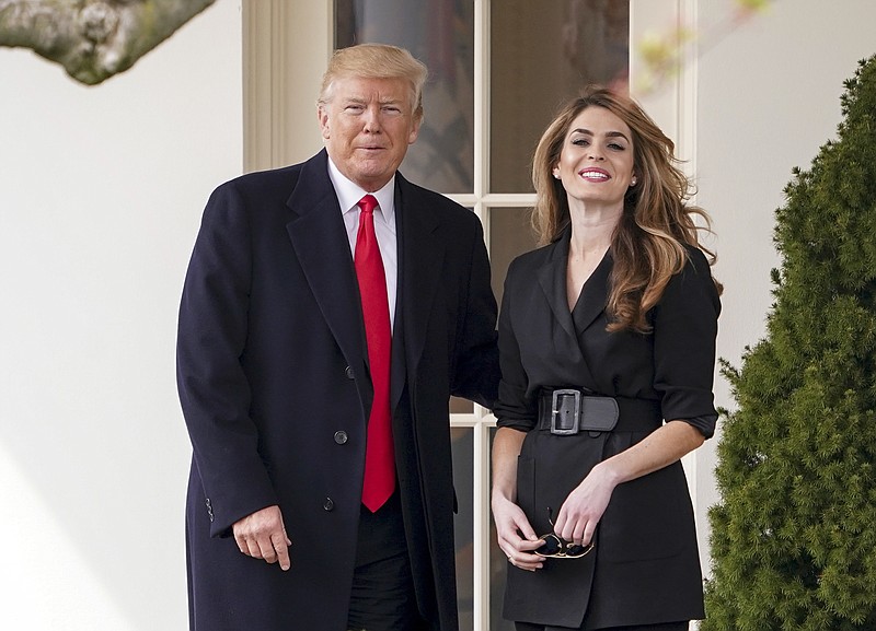 FILE - In this March 29, 2018 file photo, President Donald Trump poses for members of the media with then White House Communications Director Hope Hicks on her last day before he boards Marine One on the South Lawn of the White House in Washington. Hicks, one of President Donald Trump's most trusted and longest-serving aides, is returning to the White House. Hicks will be serving as counselor to the president, working with presidential son-in-law and senior adviser Jared Kushner.  (AP Photo/Andrew Harnik)