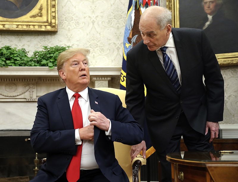 FILE - In this June 27, 2018 file photo, White House Chief of Staff John Kelly, right, leans in to talk with President Donald Trump during Trump's meeting with Portuguese President Marcelo Rebelo de Sousa, in the Oval Office of the White House in Washington.  Kelly is defending former White House national security aide, Army Lt. Col. Alexander Vindman, who raised concerns about President Donald Trump’s phone call with Ukraine’s president that spurred his impeachment. Kelly made the comments at a public forum Wednesday evening in Morristown, New Jersey.   (AP Photo/Pablo Martinez Monsivais)