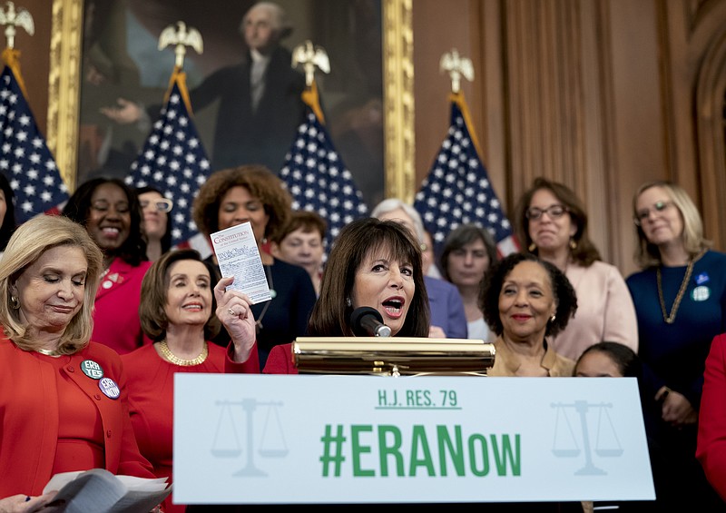 Rep. Jackie Speier, D-Calif., joined from left by Rep. Carolyn Maloney, D-N.Y., and Speaker of the House Nancy Pelosi, D-Calif., and other congressional Democrats, holds up a copy of the Constitution during an event about their resolution to remove the deadline for ratification of the Equal Rights Amendment. at the Capitol in Washington, Wednesday, Feb. 12, 2020. (AP Photo/J. Scott Applewhite)