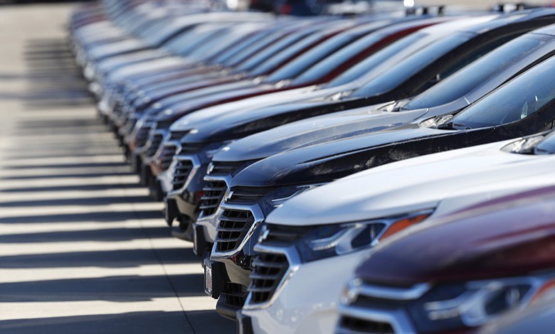 In this Sunday, Feb. 2, 2020, photograph, a long row of unsold 2020 Equinox sports-utility vehicles sits at a Chevrolet dealership in Littleton, Colo. (AP Photo/David Zalubowski)