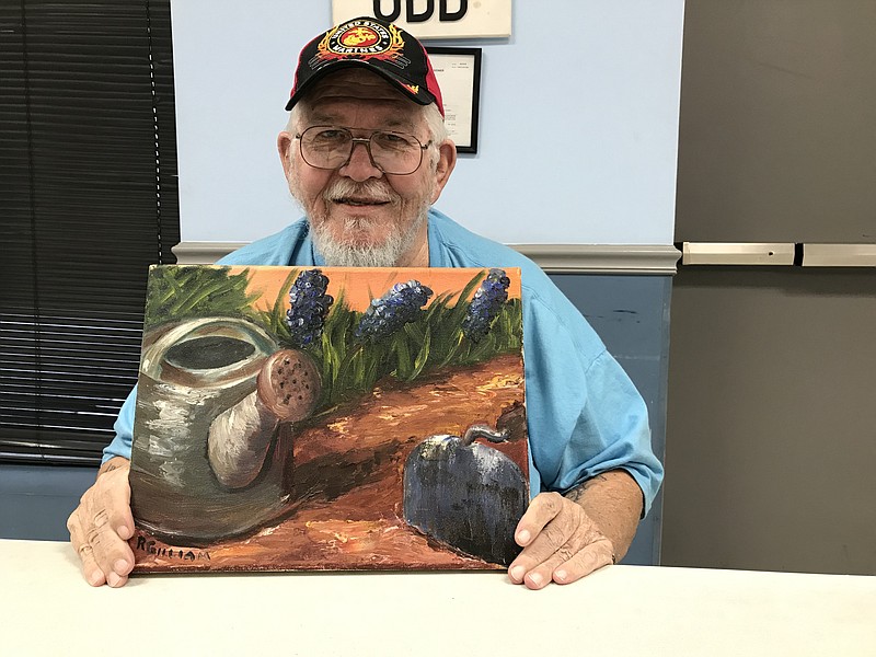 Staff photo by Sabrina Bodon / Robert Gilliam of Rossville shows off his painting, "A Walk in the Garden." Gilliam, a retired Marine Corps statistical analyst, is hosting free art therapy classes for local veterans.