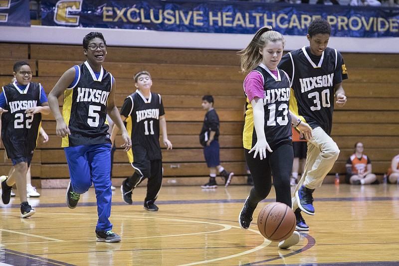 Staff photo by Troy Stolt / Hixson middle school's Emilee Bradshaw (13) dribbles down the court during the Tennessee Area 4 Special Olympics basketball tournament at McClellan Gym on campus at UTC on Friday, Feb. 14, 2020 in Chattanooga, Tenn.