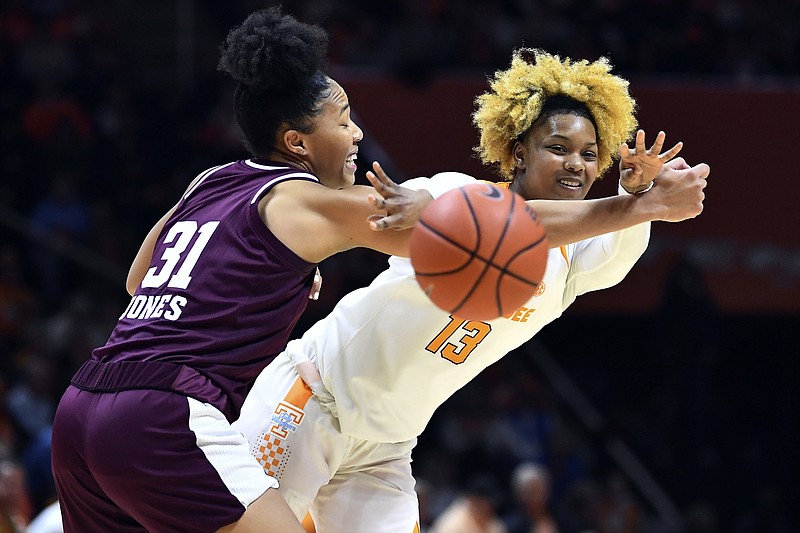 AP photo by Saul Young / Tennessee guard Jazmine Massengill from Chattanooga, right, manages to get a pass off under pressure from Texas A&M forward N'Dea Jones during Sunday's game in Knoxville. Massengill had nine points and six assists as Tennessee lost 73-71.