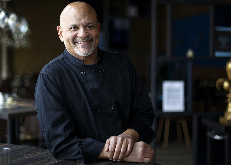 Staff photo by C.B. Schmelter / Chef Michael Adams poses inside Blue Orleans.