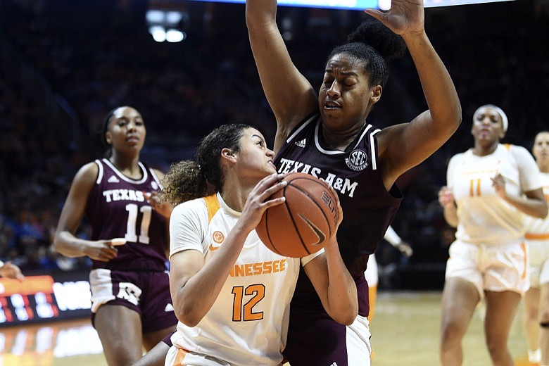 Tennessee's Rae Burrell (12) looks for the open shot while guarded by Texas A&M center Ciera Johnson during an NCAA college basketball game in Knoxville, Tenn., Sunday, Feb. 16, 2020. (Saul Young/Knoxville News Sentinel via AP)