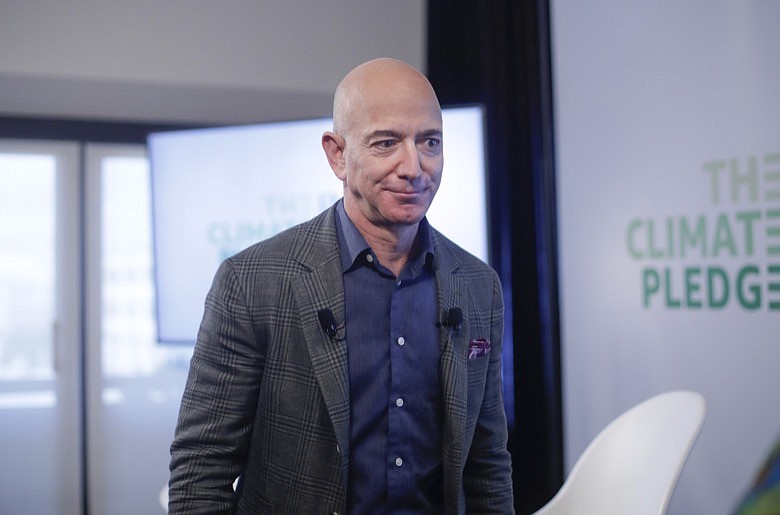 In this Thursday, Sept. 19, 2019, file photo, Amazon CEO Jeff Bezos walks off stage after holding a news conference at the National Press Club in Washington to announce the Climate Pledge, setting a goal to meet the Paris Agreement 10 years early. On Monday, Feb. 17, 2020, Bezos said that he plans to spend $10 billion of his own fortune to help fight climate change. (AP Photo/Pablo Martinez Monsivais)