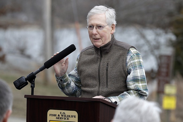 Senate Majority Leader Mitch McConnell, R-Ky., speaks after watching Asian carp being harvested from Kentucky Lake near Golden Pond, Ky., Monday, Feb. 17, 2020. The harvest method mainly targets bighead and silver carp, two of the four invasive carp species collectively known as Asian carp in the U.S. Both bighead and silver carp devour plankton that form the base of the food chains, grow rapidly and reproduce prolifically, outcompeting many native fish. (AP Photo/Mark Humphrey)