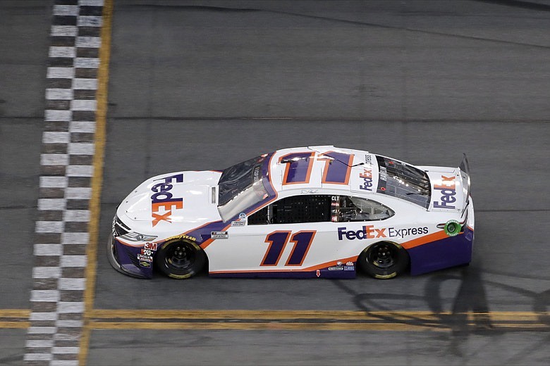 Denny Hamlin (11) gets to the line to win the second stage during the NASCAR Daytona 500 auto race Monday, Feb. 17, 2020, at Daytona International Speedway in Daytona Beach, Fla. Sunday's running of the race was postponed by rain. (AP Photo/Chris O'Meara)