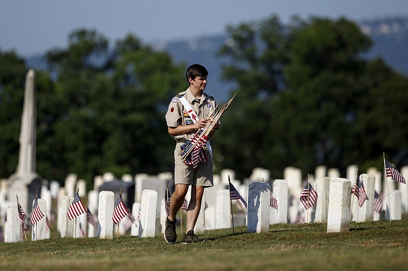 Staff File Photo By C.B. Schmelter / The filing of Chapter 11 bankruptcy by the national Boy Scouts of America organization will not keep participants in the separate local Cherokee Area Council from activities such as its annual Memorial Day activity of placing flags at the more than 50,000 graves at the Chattanooga National Cemetery.