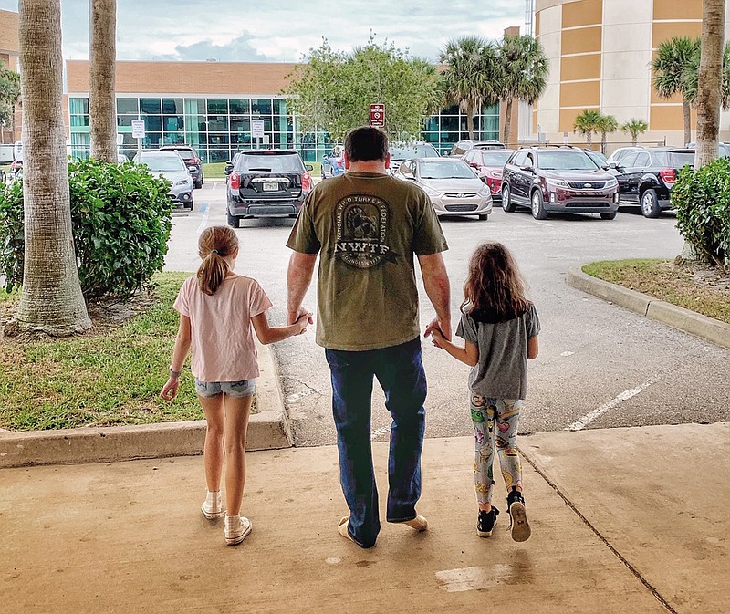 Roush Fenway Racing photo via AP / NASCAR Cup Series driver Ryan Newman and his daughters, Brooklyn Sage, left, and Ashlyn Olivia, leave Halifax Medical Center in Daytona Beach, Fla., on Wednesday afternoon. Newman was released about 42 hours after his frightening crash close to the finish line at the Daytona 500.