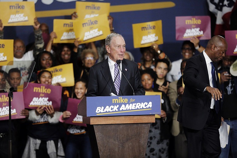 Democratic presidential candidate and former New York City Mayor Michael Bloomberg speaks during a campaign rally at the Buffalo Soldier Museum in Houston, Thursday, Feb. 13, 2020. Houston Mayor Sylvester Turner stands at right. (Elizabeth Conley/Houston Chronicle via AP)