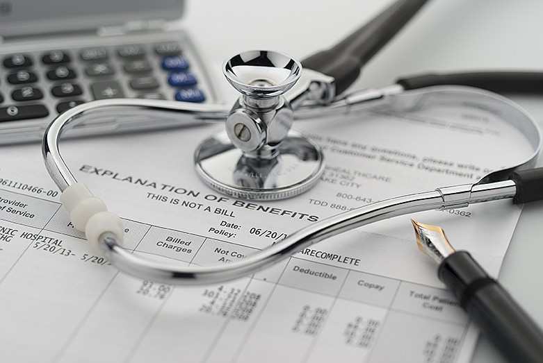 Figuring cost of health care and benefits with stethoscope and calculator. / Getty Images/iStockphoto/Maudib