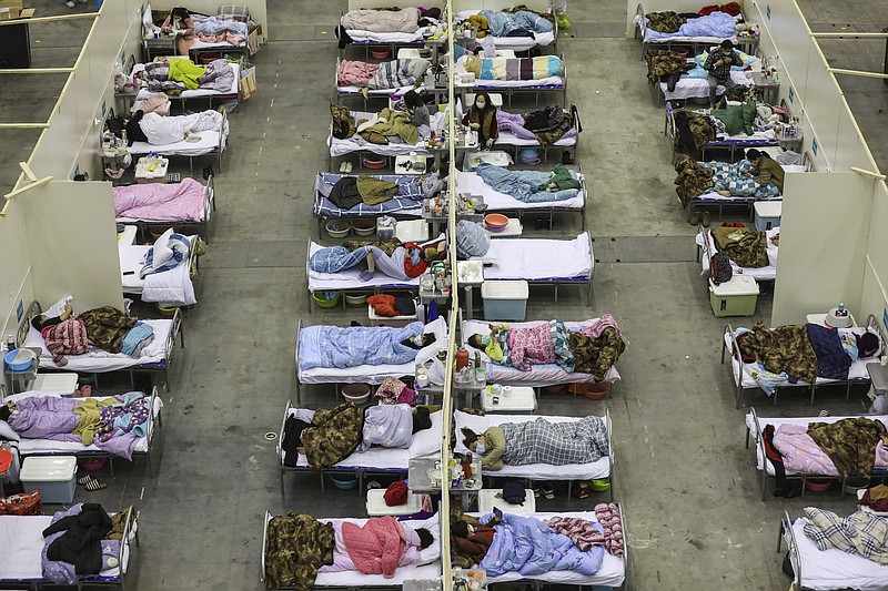 Photo by Chinatopix via The Associated Press / In this Feb. 18, 2020, photo, COVID-19 patients recuperate in a temporary hospital converted from an exhibition center in Wuhan in central China's Hubei province.