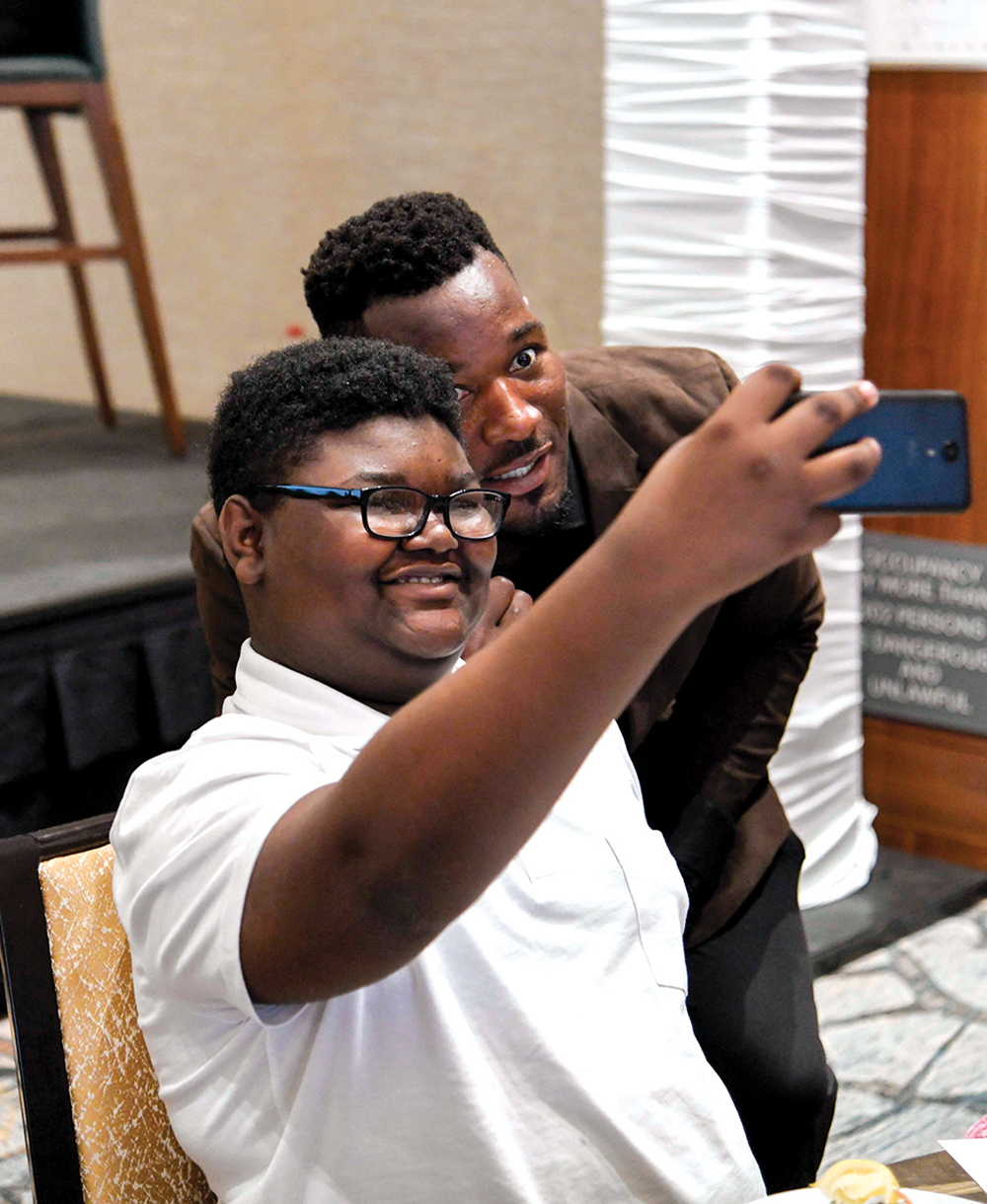 Chance Smith-Usher gets a selfie with guest speaker Derrick Coleman./ Photo by Mark Gilliland