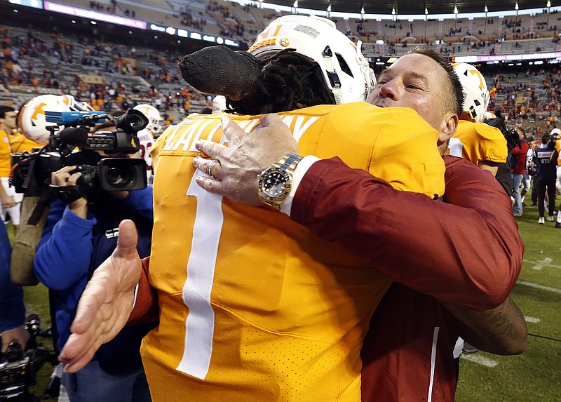 AP photo by Wade Payne / Alabama offensive analyst Butch Jones and Tennessee receiver Marquez Callaway embrace after the Crimson Tide's 58-21 win in Knoxville during the 2018 season.