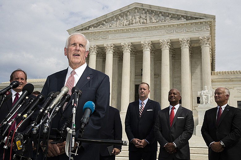 In this Sept. 9, 2019, file photo, Tennessee Attorney General Herbert Slatery, with a bipartisan group of state attorneys general speaks to reporters in front of the U.S. Supreme Court in Washington. Slatery has asked the state Supreme Court to set nine execution dates, bucking a national movement away from capital punishment. Slatery quietly filed the request on Friday, Sept. 20, with no explanation, and the state Supreme Court posted it on its website on Tuesday. (AP Photo/Manuel Balce Ceneta, File)