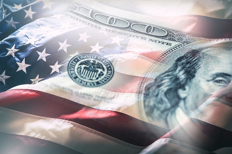 USA flag and American dollars. American flag blowing in the wind and 100 dollars banknotes in the background - stock photo budget tile money tile politics tile / Getty Images
