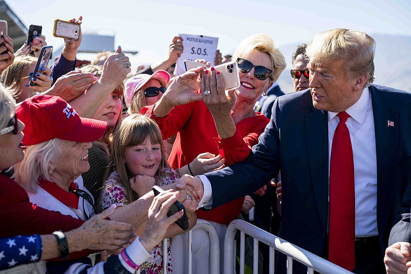 Doug Mills, The New York Times / President Donald Trump greets supporters as he arrives in Palm Springs, Calif., for a fundraiser at the Porcupine Creek Golf Course on Wednesday.