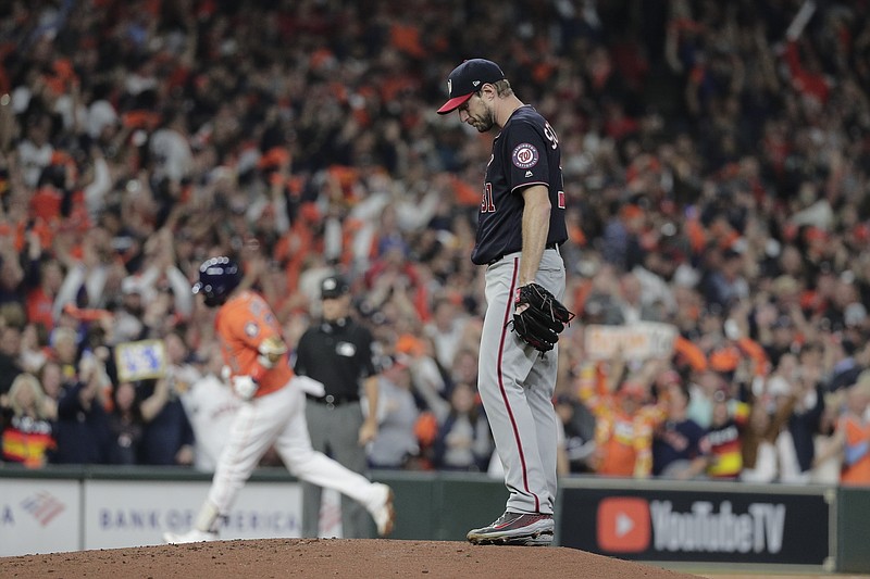 AP photo by David J. Phillip / Washington Nationals starter Max Scherzer stands on the mound as the Houston Astros' Yuli Gurriel runs the bases after a hitting a home run during Game 7 of the World Series last Oct. 30 in Houston. The Nationals rallied to win 6-2 for the first World Series title in franchise history.
