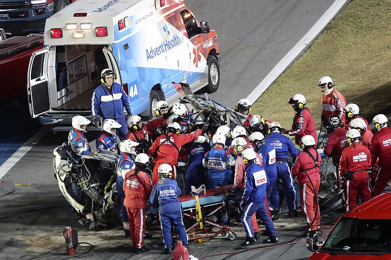AP photo by David Graham / Rescue workers remove NASCAR Cup Series driver Ryan Newman from his car after he crashed on the last lap of the Daytona 500 on Monday at Daytona International Speedway in Daytona Beach, Fla.
