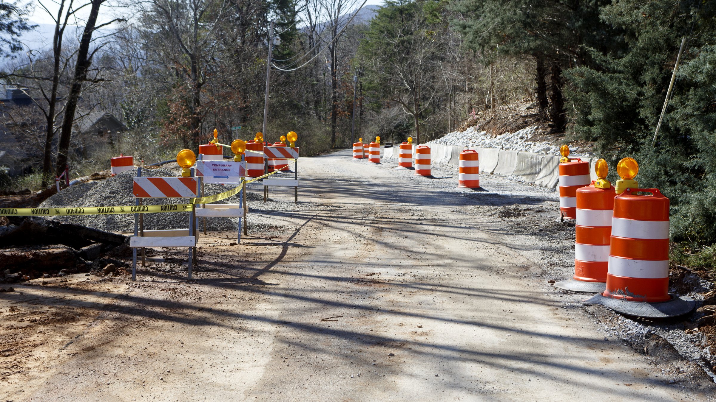 Staff photo by C.B. Schmelter / Traffic cones and traffic tape are seen along Sunset Drive on Friday, Feb. 21, 2020 in Signal Mountain, Tenn. Recent rains have cause the ground under the road to shift.