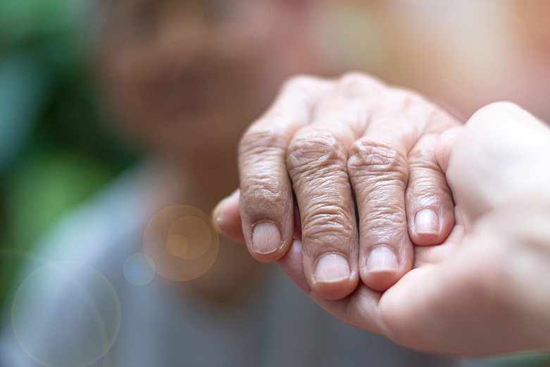 Caregiver, hand holding, helping hand, elderly care. / Getty Images/iStockphoto/Pornpak Khunatorn