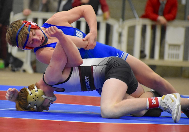 Staff photo by Patrick MacCoon / Cleveland junior Trae McDaniel works to turn his opponent in the TSSAA Class AAA 126-pound final Saturday in Franklin. McDaniel won 7-5 to help the Blue Raiders win the team title.