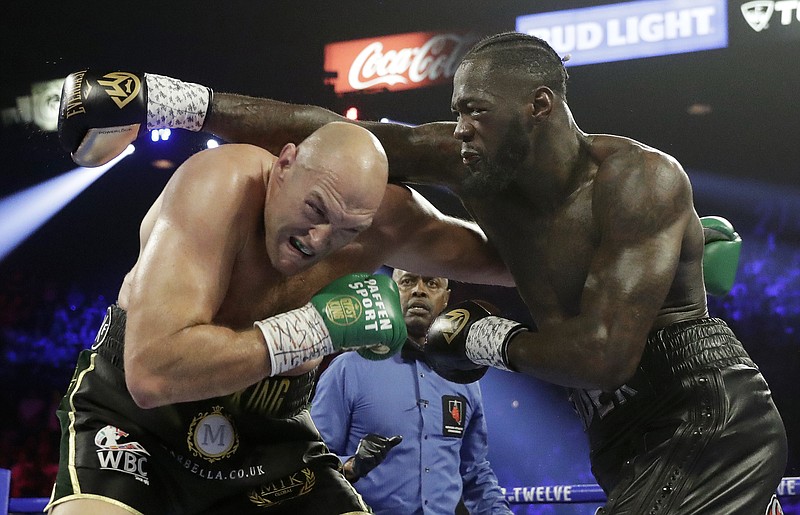 AP photo by Isaac Brekken / A punch from Deontay Wilder, right, misses Tyson Fury during their WBC heavyweight fight Saturday night in Las Vegas.