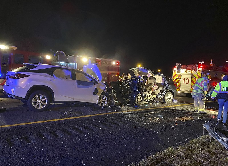 First responders from the Midway Fire Department survey the scene of a fatal accident on Interstate 95, which claimed the lives of multiple people, early Sunday morning, Feb. 23, 2020, in Liberty County, Ga. (AP Photo/Lewis Levine)