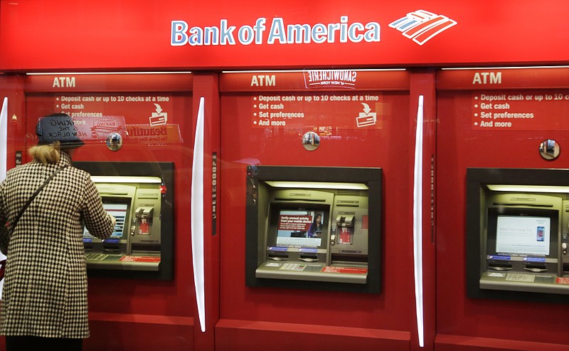 FILE - In this Nov. 23, 2015 file photo, a customer uses an ATM at a Bank of America in New York. The banking industry collectively made $233.1 billion in profits in 2019, the Federal Deposit Insurance Corporation said Tuesday, Feb. 25, 2020, the industry's second-most profitable year ever. The slight drop in profits from 2018 is due to the drop in interest rates, which happened in the second half of last year. (AP Photo/Mark Lennihan, File)