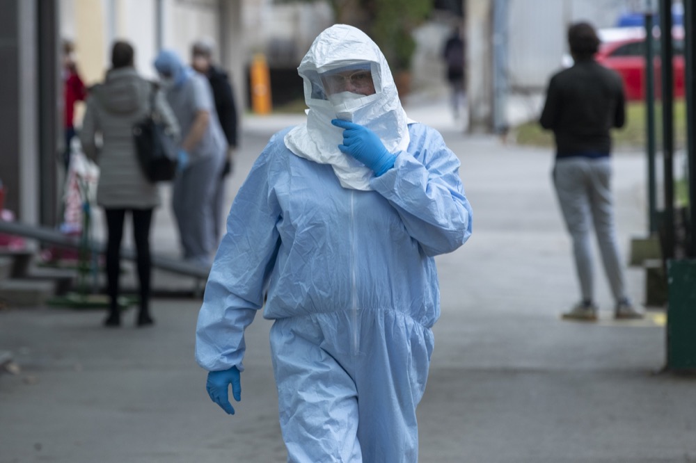 A health worker wears protective suit at the infectious disease clinic in Zagreb, Croatia, where the first coronavirus case in Croatia is hospitalized, Tuesday, Feb. 25, 2020. Croatia confirmed its first case of coronavirus in a man who had been to Milan, the capital of Lombardy, Italy. (AP Photo/Darko Bandic)
