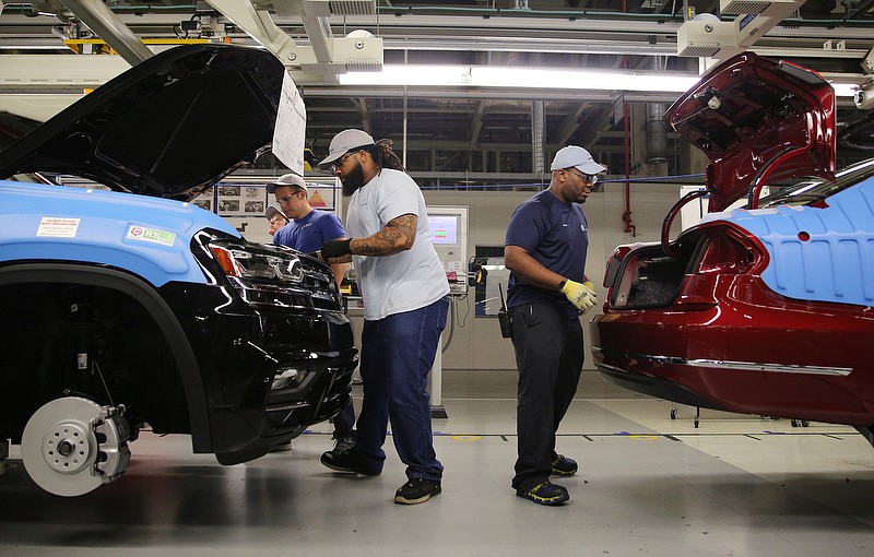 Volkswagen employees walk around the outside of cars on an assembly line checking items as they go at the Volkswagen Plant Thursday, Aug. 31, 2017, in Chattanooga, Tenn. Each car is meticulously tested and inspected by the time it makes it to the end of the assembly line. 