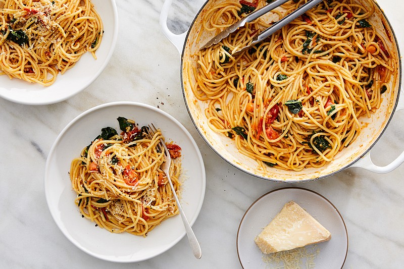 FILE -- One-pot spaghetti with cherry tomatoes and kale, in New York, Dec. 10, 2018. The majority of these recipes will deliver a whole meal in a single pot, pan or skillet, full stop. Food Stylist: Simon Andrews. (Ryan Liebe/The New York Times)