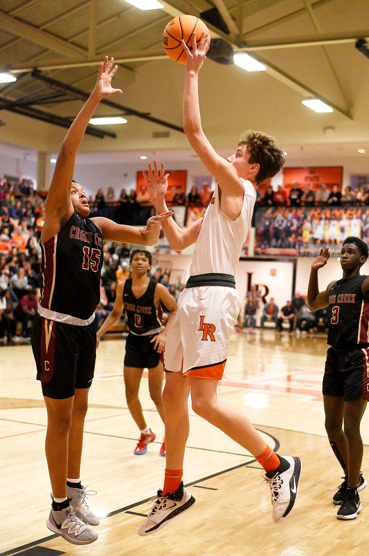 Staff Photo by Robin Rudd / LaFayette's Aidan Hadaway (3) shoots over Cross Creek's Corey Trotter (15). The LaFayette Ramblers hosted the Cross Creek Razorbacks in the quarterfinals of the GHSA boys state basketball tournament on February 25, 2020.