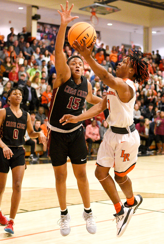 Staff Photo by Robin Rudd / LaFayette's Jaylon Ramsey (1) shoots around Cross Creek's Corey Trotter (15) in their state quarterfinal game Tuesday night at LaFayette High School.