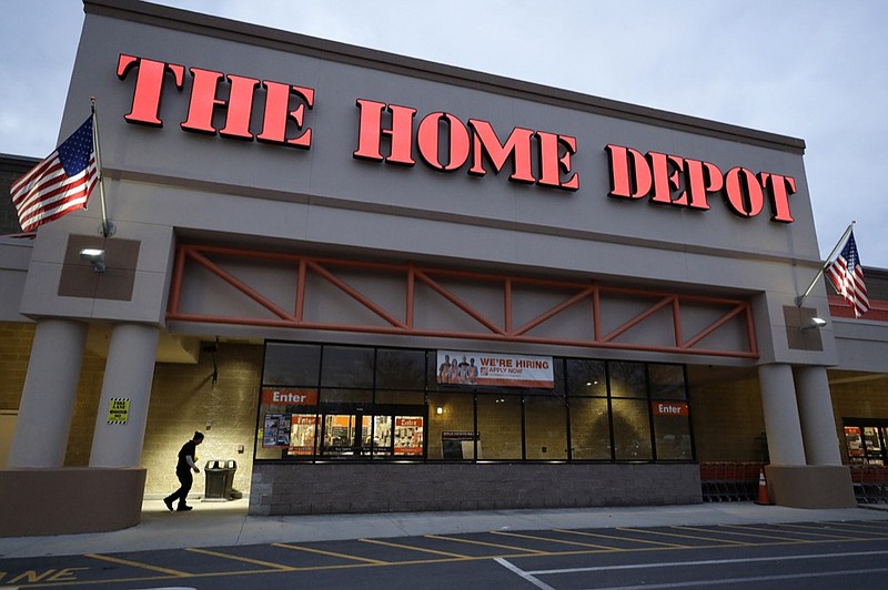 In this Monday, Jan. 27, 2020 photo a passer-by, below left, walks toward an entrance to a Home Depot store location, in Boston. Home Depot Inc. reports financial results on Tuesday, Feb. 25. (AP Photo/Steven Senne)


