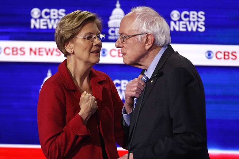 From left, Democratic presidential candidates, Sen. Elizabeth Warren, D-Mass., talks with Sen. Bernie Sanders, I-Vt., during a Democratic presidential primary debate at the Gaillard Center, Tuesday, Feb. 25, 2020, in Charleston, S.C., co-hosted by CBS News and the Congressional Black Caucus Institute. (AP Photo/Patrick Semansky)